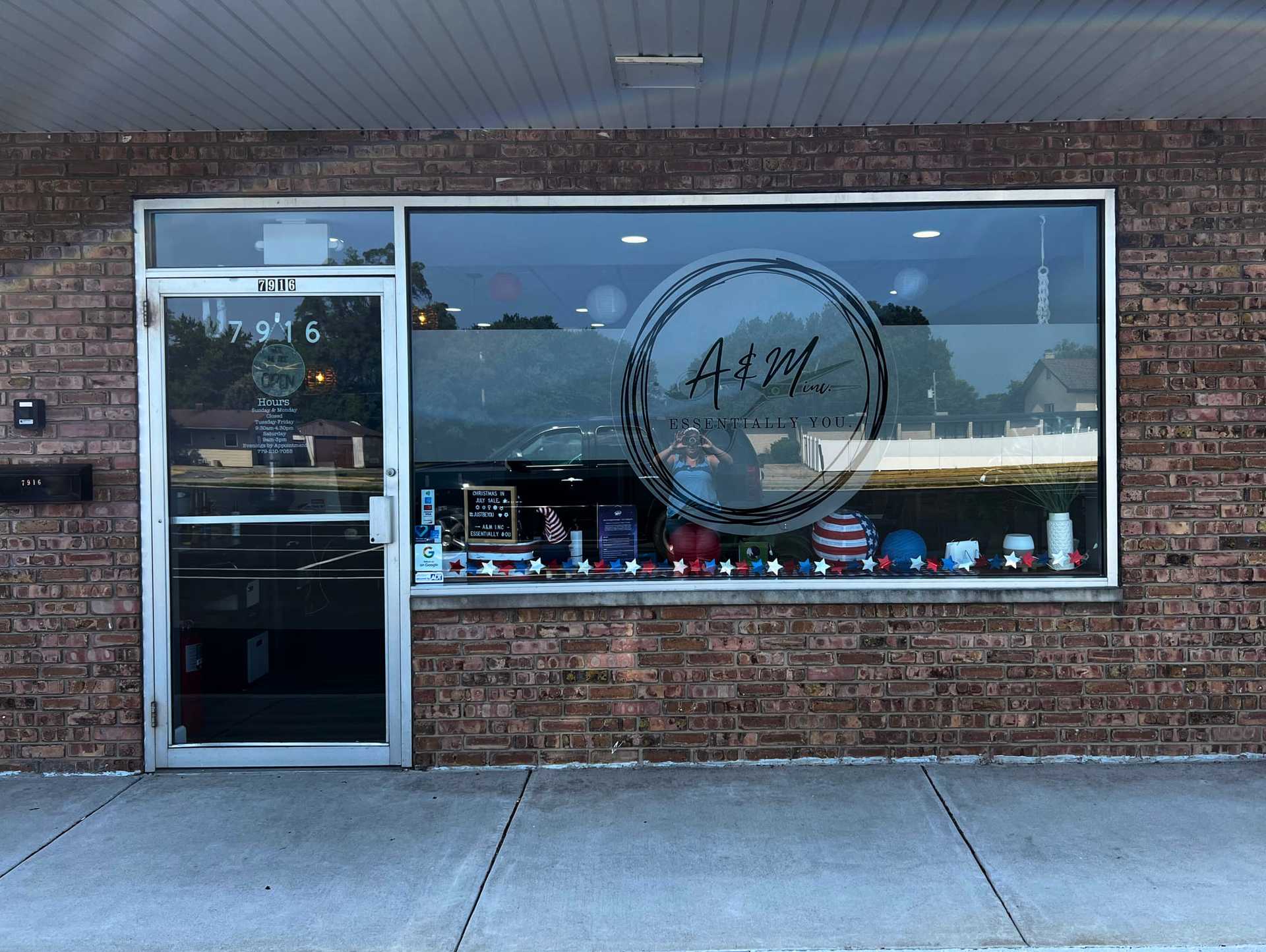 Storefront of "A&M" with a display window featuring various decorative items and a glass door entrance.