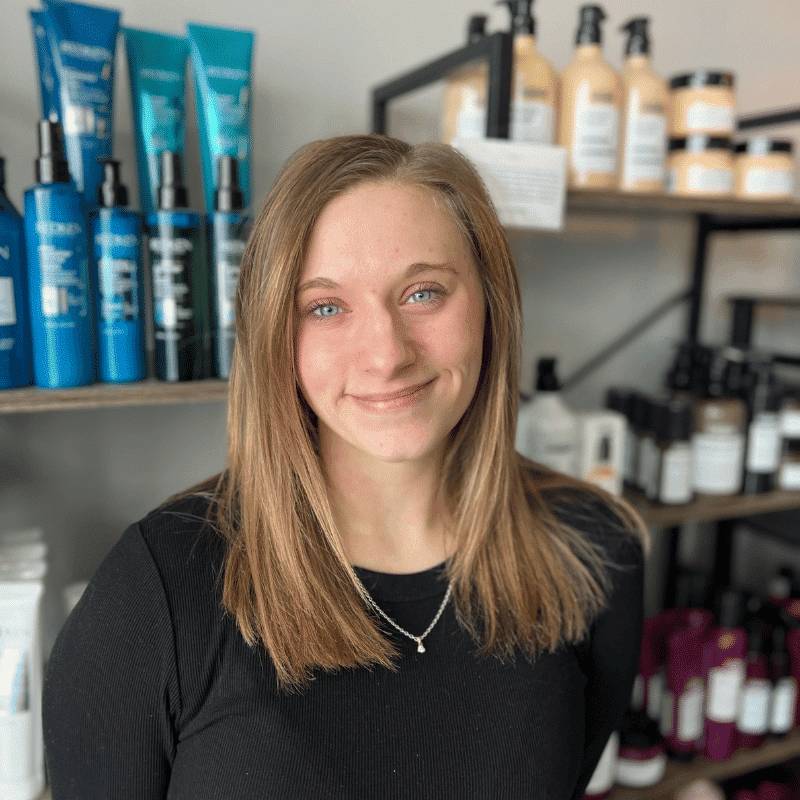 Portrait of Kiersten, a professional stylist at A & M Inc., showcasing their expertise and style.